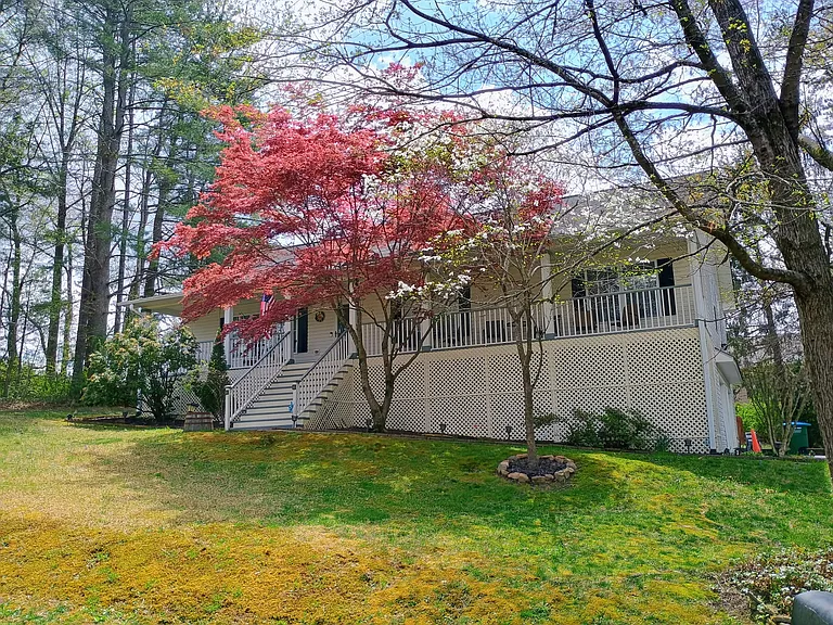 View of the front of the house and cozy porch during springtime.
