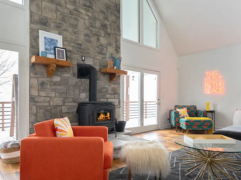 Wood burning fireplace and large stone wall