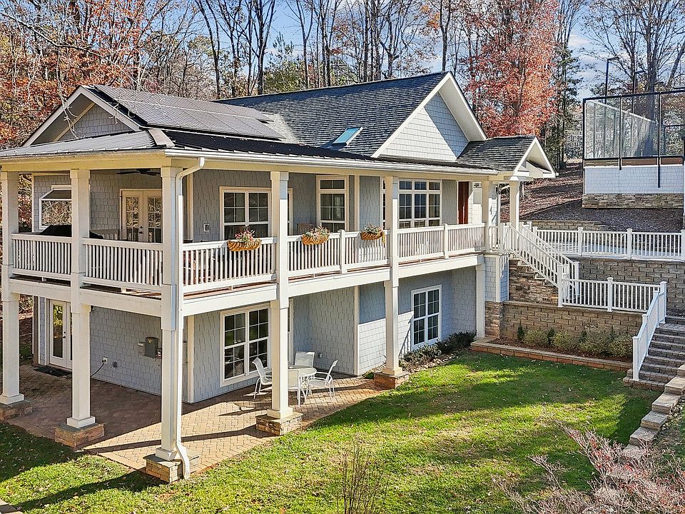 Two-story home with tennis court nestled on private Lake Wylie cove.