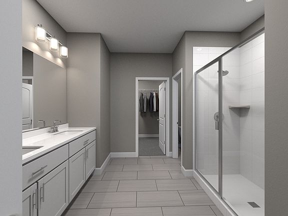A large walk-in closet and dual vanity sinks bring luxury to your primary suite.