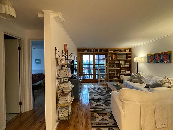 Living room, guest/hallway bath, and master bedroom as seen from dining area.