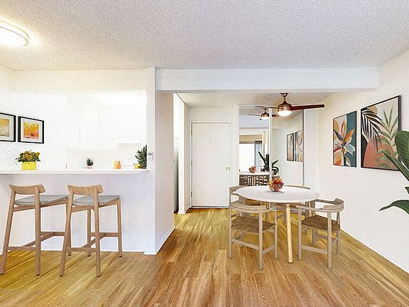 Dining area, kitchen, and living room at Village Pointe Apartment Homes