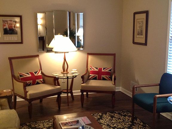 Living Room on first floor. TV on bottom floor den. Front door is to the left out of view.