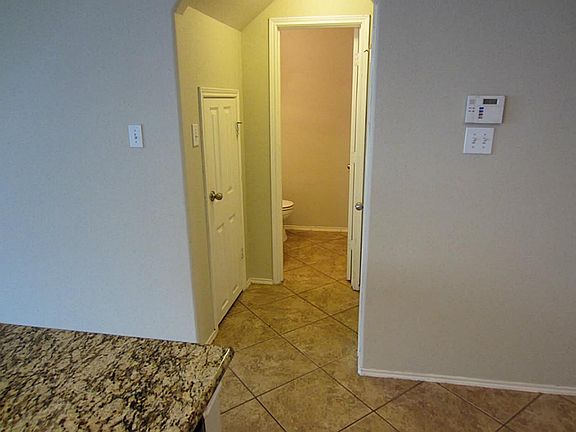 Entrance to garage and powder bathroom pictured.