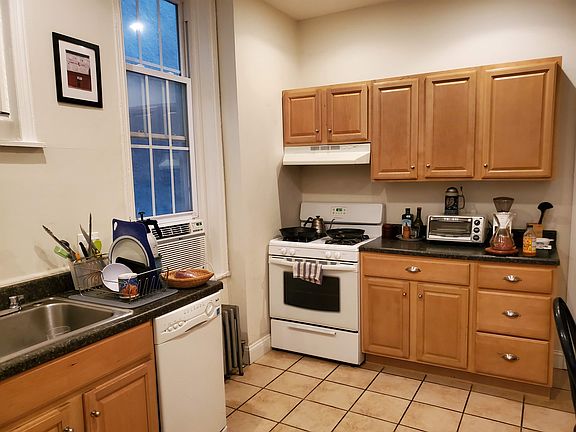 Kitchen with window to alleyway to private yard.