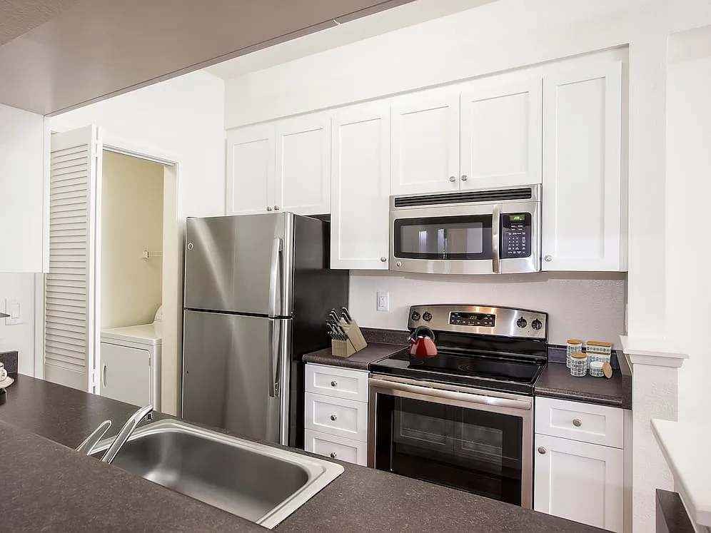 Classic Package I kitchen with stainless steel appliances, white cabinetry, laminate countertops, and hard surface flooring - eaves Dublin