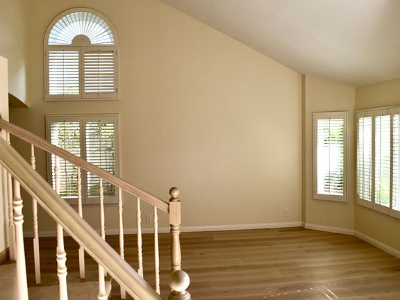 Living room with new hardwood floors and plantation shutters