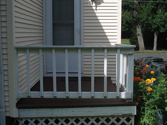 Rear entrance to apartment, private deck, adjacent to driveway off street parking.