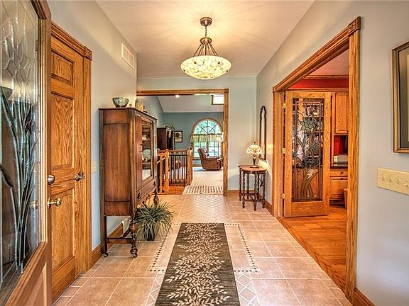 13x7 level entry hall with access to the living room and den.  Note leaded glass door inserts.