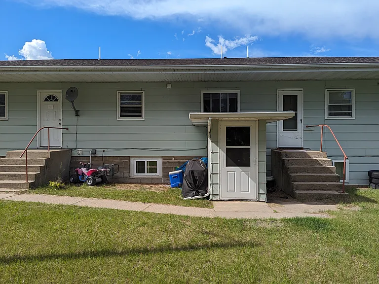 Rear of building, door in center is entrance to lower level (where Unit 5 is).