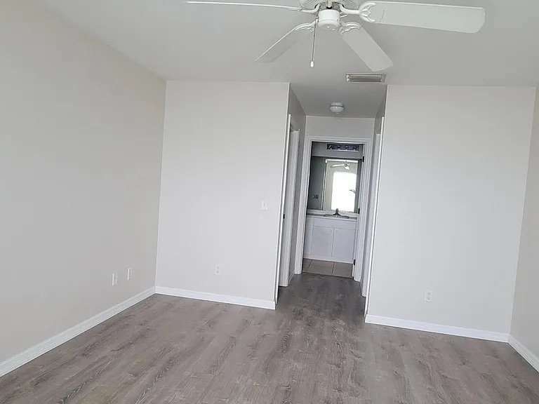Master Bedroom looking between Dual Walk-In Closets to Master Bath