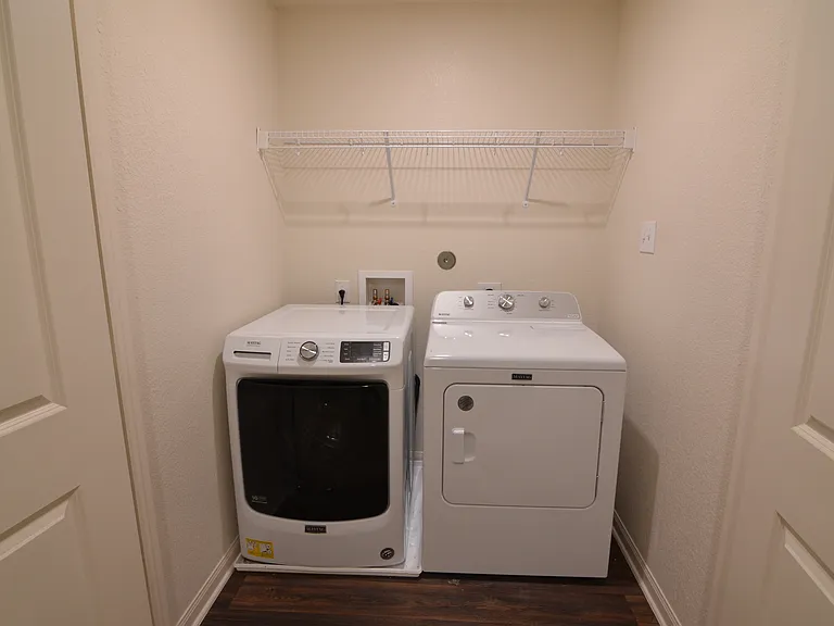 In-unit laundry area with washer and dryer included for added convenience.