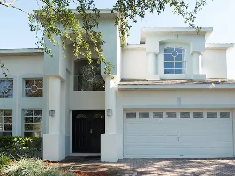 Behold the magnificent exterior of our DisneyEstate! The backyard offers stunning views of your private pool, championship golf course, and resort clubhouse with incredible amenities like Lap Pool, Pickleball, Tennis, and Children's Playground.