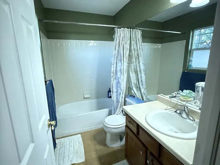 Primary bedroom en suite bath. All bathrooms have tiled floors.