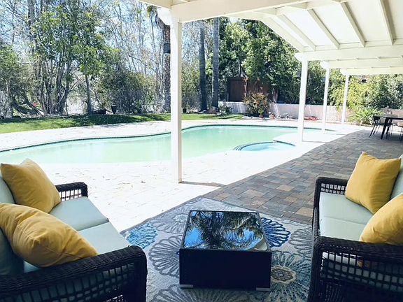 Large covered deck area provides comfortable poolside lounging year round.
