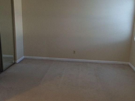 Master bedroom with mirrored sliding closet doors