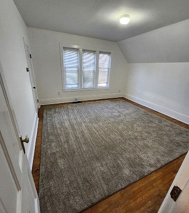 Living room hardwood floor with carpet.