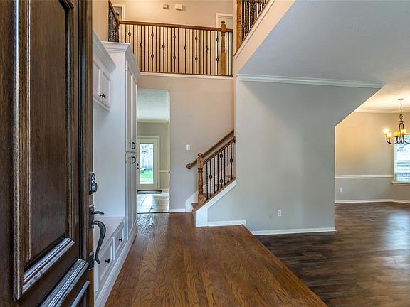 Two story entry with custom built cabinets