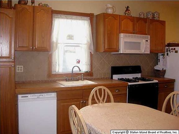 New kitchen, with new tiled floor, tiled counter top & backsplash.