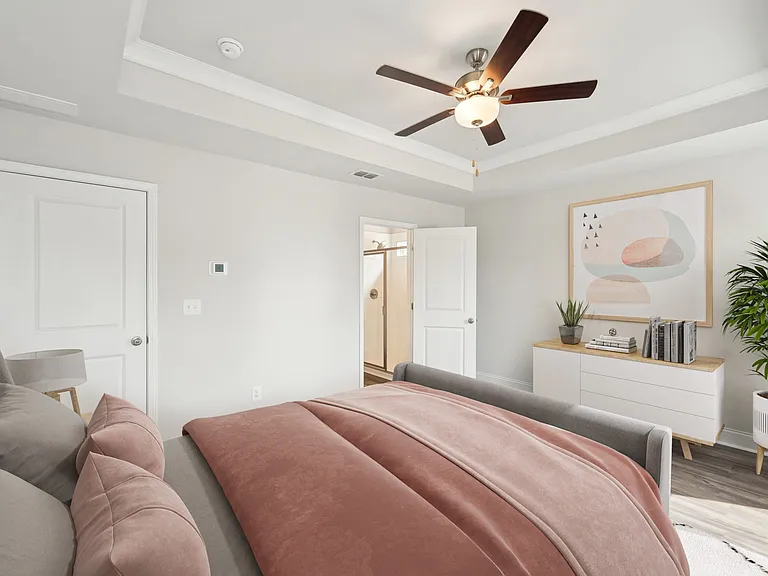 Luxurious primary bedroom with a king bed and abundant natural light.