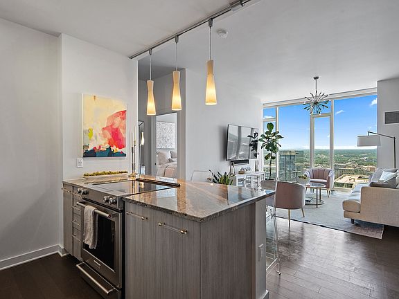 Efficient kitchen area includes area for counter-height bar stools at the breakfast bar.