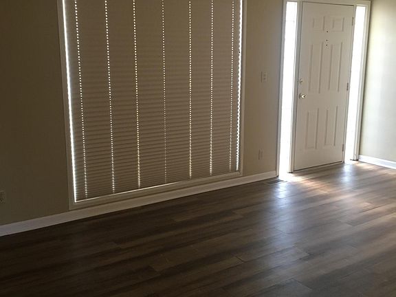 Living room. All windows have custom blinds.