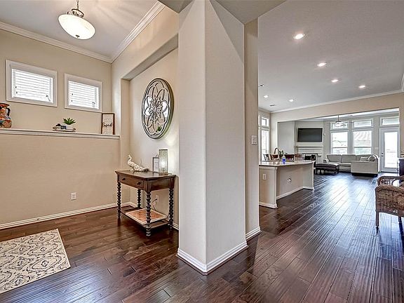 Angle from the corner of the first bedroom/bath located at the front of the home! Sparkling wood floors welcome you in.