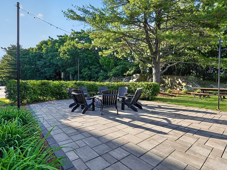 Unwind in the serene outdoor space at Eagle Rock Apartments at Swampscott. Enjoy cozy seating surrounded by lush greeneryperfect for relaxation or gathering with friends. Explore your new home today!