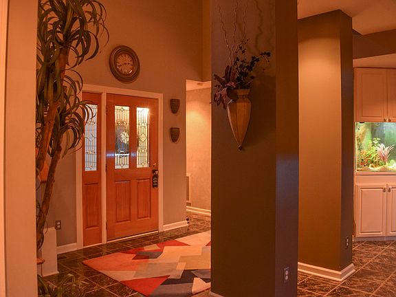 Front door : front door and large columns in foyer area, ceramic tile floor,built in aquarium