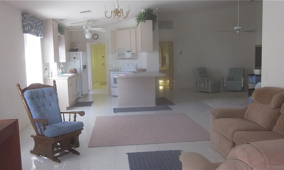 VERY OPEN CONCEPT WITH TILED KITCHEN, DINING AREA & DEN