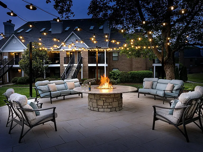 Outdoor fire pit and lounge space at dusk