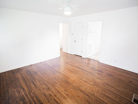 Living room - The kitchen is through the opening on the right and 3 bedrooms and bathroom are through the door on the left.