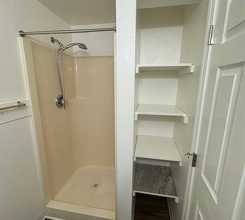 Master bathroom has a European-style showerhead and extra storage shelves!