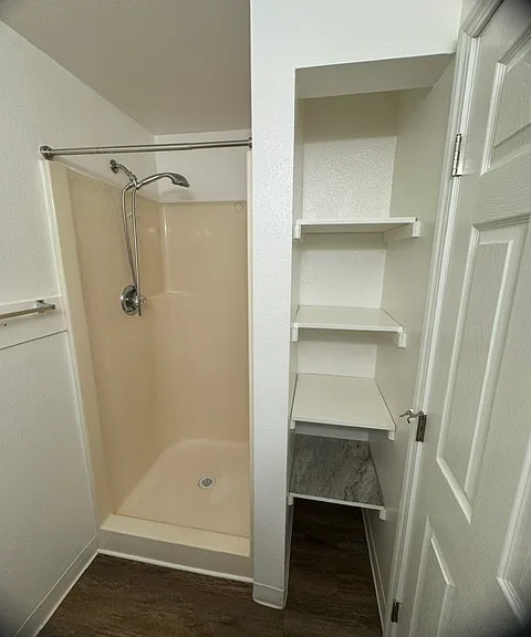 Master bathroom has a European-style showerhead and extra storage shelves!