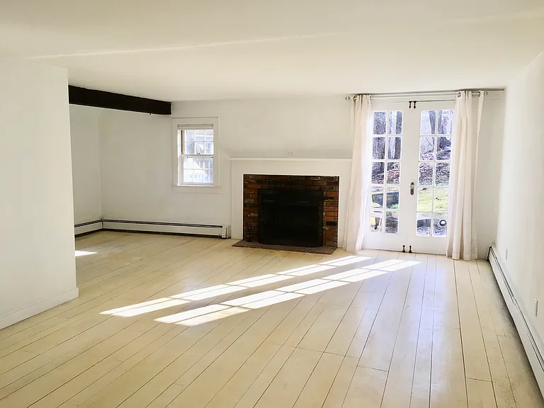 Large L shaped LR with 3 exposures and working fireplace, screened French doors open to side yard and private hilltop sitting area.