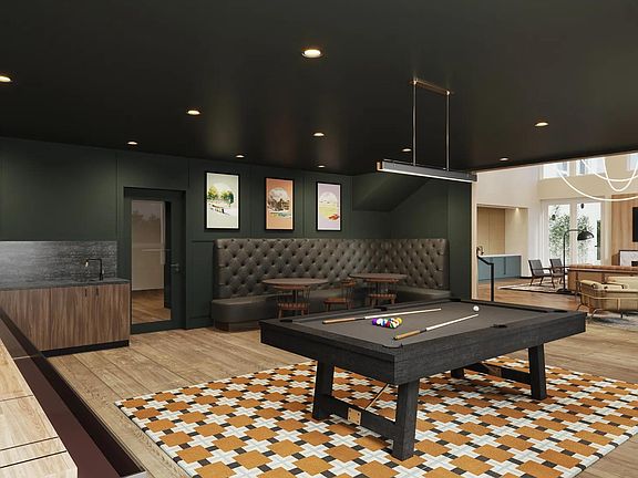 Game room with billiards, shuffleboard, and game tables at Modera Shoreline apartments in Shoreline, WA.
