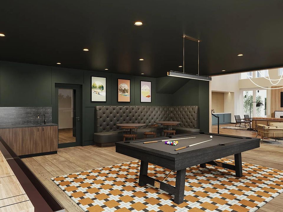 Game room with billiards, shuffleboard, and game tables at Modera Shoreline apartments in Shoreline, WA.