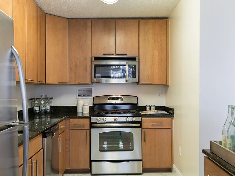 Renovated kitchens with stainless steel appliances, dark light maple cabinets and granite counters