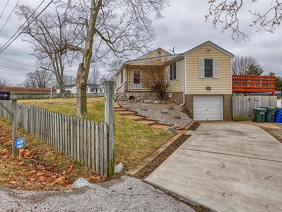 Newer concrete driveway and gravel area for multiple cars to park