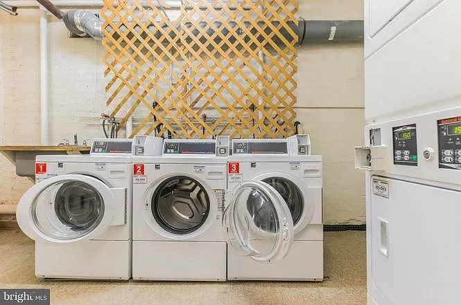 Laundry room with washers and dryers in building- conveniently accepts both credit cards and coins