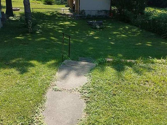Big backyard with a fire pit.