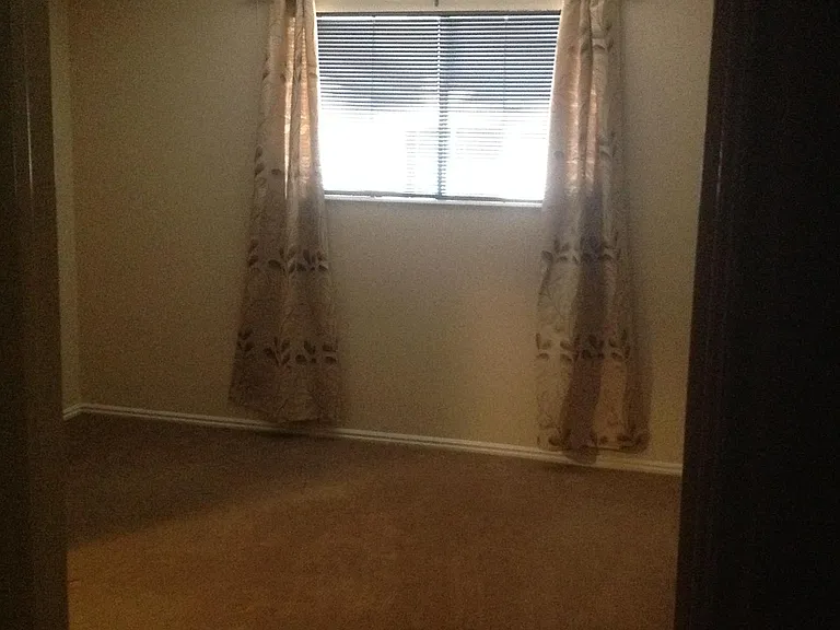 Bathroom door to primary bedroom