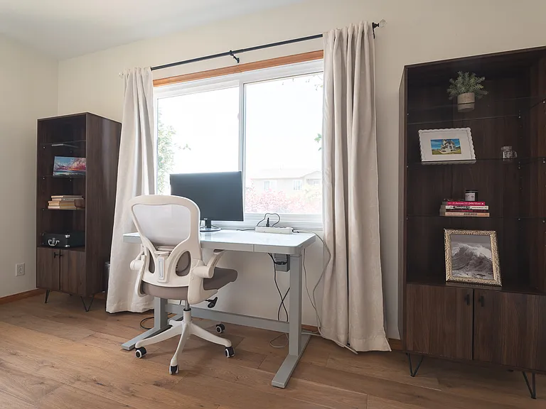 Another bedroom downstairs with an office setup