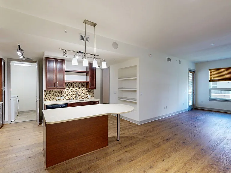 Apartment Kitchen with Stainless Steel Appliances, Dining and Living Room with Wood Style Flooring