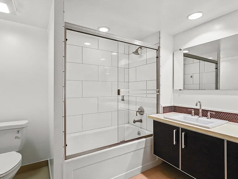 Bathroom with Full-Size Bathtub and Glass Doors