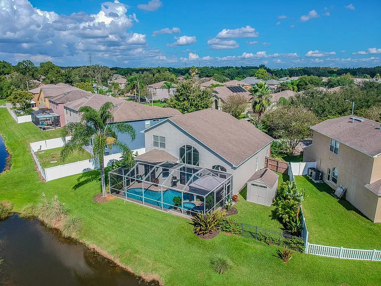 View of Back of the Home with Pond