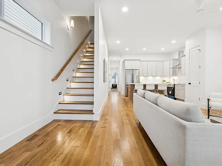 The main floor (second floor) features an open concept floor plan between the main living room and fully equipped, modern kitchen, and primary bedroom.