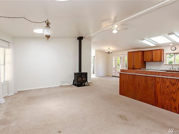 As you enter, you're greeted with a light-filled living room with solar tubes and propane stove.