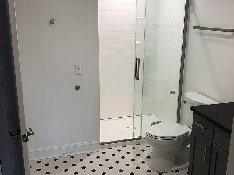 Glass shower enclosure and tile floor