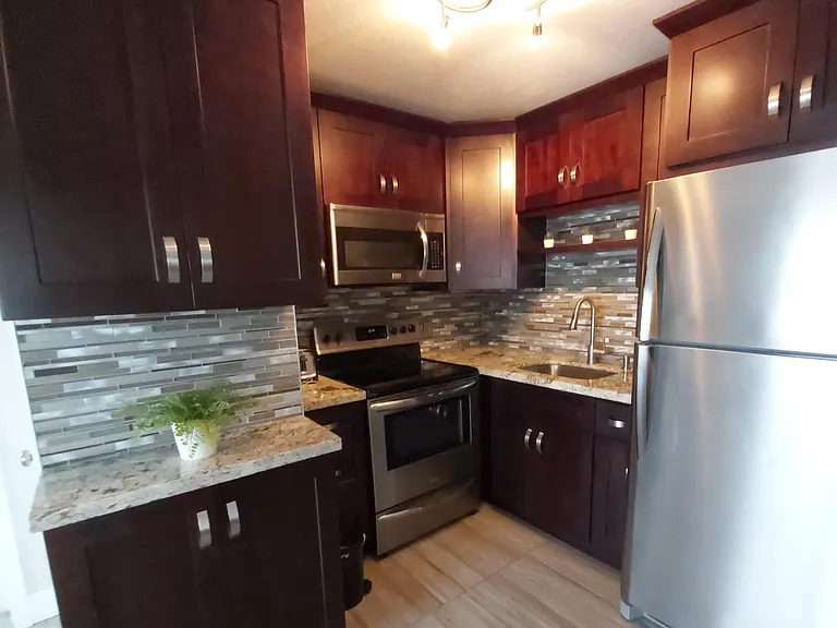 Kitchen, with microwave, refrigerator,
and stove.